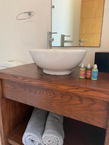 a bathroom counter with a sink and a mirror at Beachfront Loft Amara Cancun in Cancún