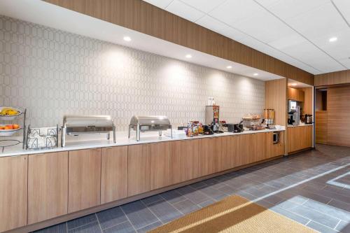 a restaurant with a counter and a food court at Microtel Inn Suites by Wyndham South Hill in South Hill