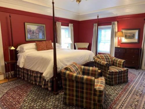 a bedroom with a bed and two chairs at The INN at Ormsby Hill in Manchester