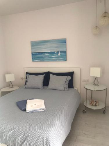 a bedroom with a bed with two tables and two lamps at CASA ROSA in Costa Teguise