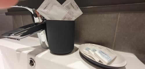 a black trash can sitting on top of a toilet at O Près de la Lienne, maison de campagne de charme, accord parfait entre confort et authenticité in Lierneux