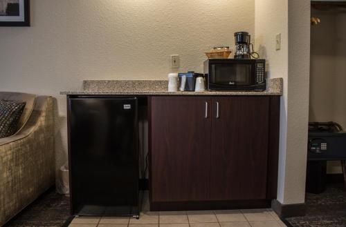 a microwave sitting on top of a kitchen counter at Cobblestone Suites - Oshkosh in Oshkosh