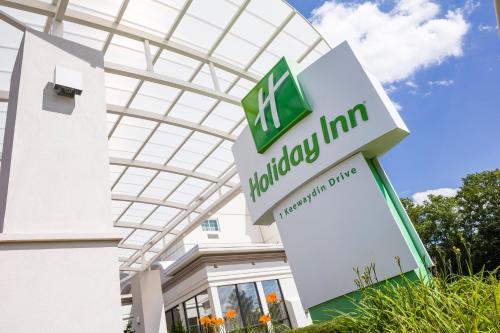 a sign in front of a vmukong inn building at Holiday Inn Salem by IHG in Salem