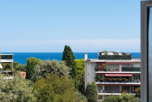 a view of a building with the ocean in the background at Coup de coeur! Vue mer! Terrasse dangle! in Antibes