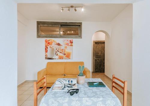 a dining room with a table and a couch at Appartamenti Ischia Casa Don Peppe in Ischia