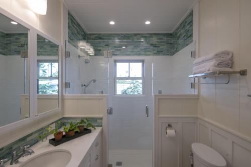 a bathroom with a sink and a shower and a toilet at Gorgeous Renovated 1937 Plantation Style Beach House 50 Steps to the Center of the Beach home in Kailua