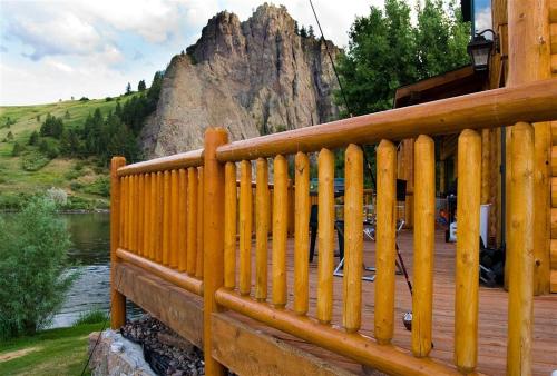 a wooden deck with a mountain in the background at River's Bend Lodge in Cascade