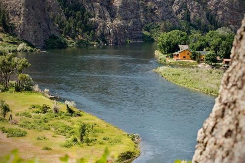 a river with a house on the side of a mountain at River's Bend Lodge in Cascade