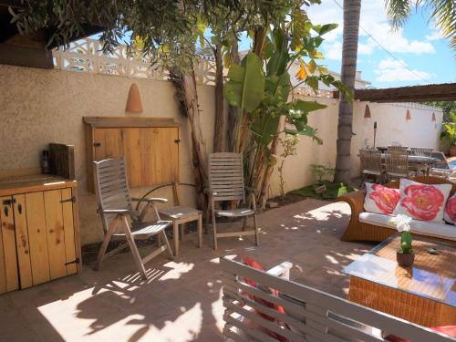 a patio with chairs and a couch and a table at Belvilla by OYO Villa Jazmin in Albir
