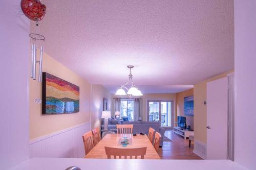 a dining room and living room with a dining table at Walk to Hilton Head Island Beach Villa with Balcony in Hilton Head Island