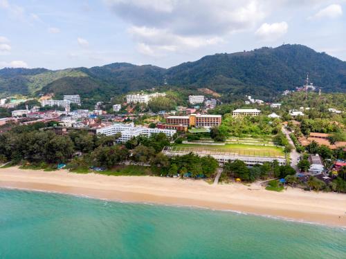 an aerial view of a beach with mountains in the background at Avista Grande Phuket Karon - MGallery in Karon Beach