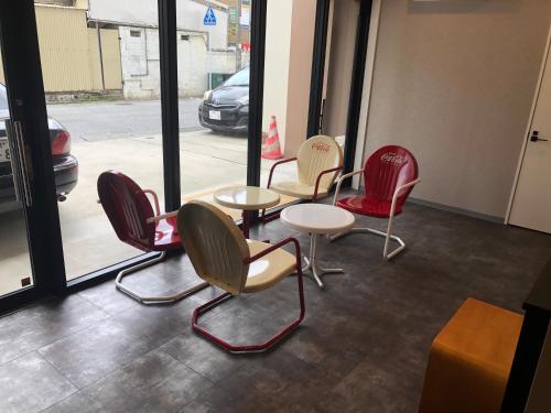 a row of chairs and tables in front of a window at Clean Hotels in Higashimachi in Naha
