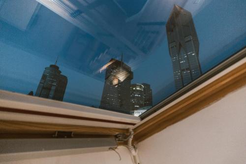 a window with a view of skyscrapers at Shanghai Fish Inn People Square in Shanghai