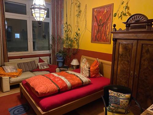a bedroom with a bed and a couch in it at Mediterranean Room - Private Room in Mannheim