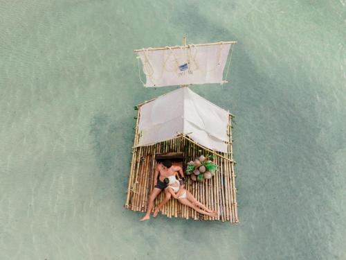 a woman laying on a cage in the water at Rest Sea Resort Koh Kood in Ko Kood