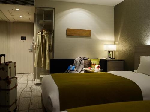 a bedroom with a bed and a desk at Mitsui Garden Hotel Ginza Premier in Tokyo