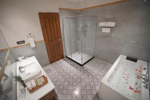 a bathroom with a shower and a toilet and a sink at Hotel Rah Bagh - Luxury Boutique Hotel in Bāgh Chandpura