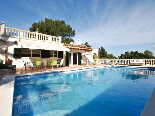 a large swimming pool in front of a house at Belvilla by OYO Casa Aim Eri in Alcudia