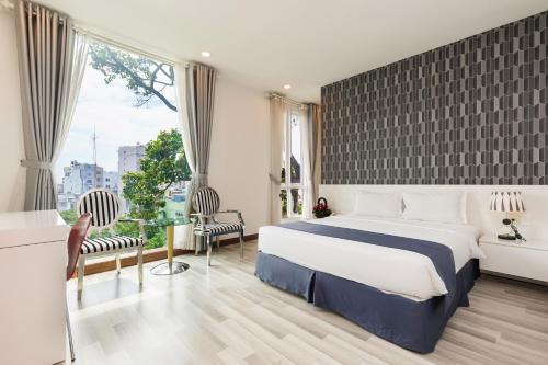 pokój hotelowy z łóżkiem i dużym oknem w obiekcie Lam Kinh Hotel w Ho Chi Minh