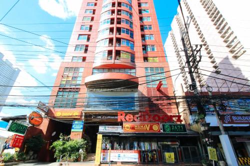 a tall building with a store in front of it at RedDoorz at The Providence Tower in Manila