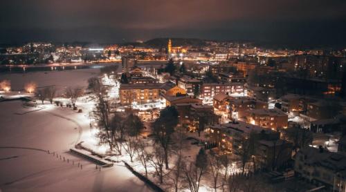 a view of a city at night with lights at Original Sokos Hotel Seurahuone Savonlinna in Savonlinna