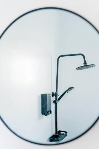 a round mirror with a desk lamp in front of it at Fun Trip - Fu May Sea View Holiday house l 無敵海景交誼廳 l 附汽機車租賃 l in Taitung City