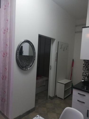 a bathroom with a mirror on the wall at Apartman Jasna, in Pirot