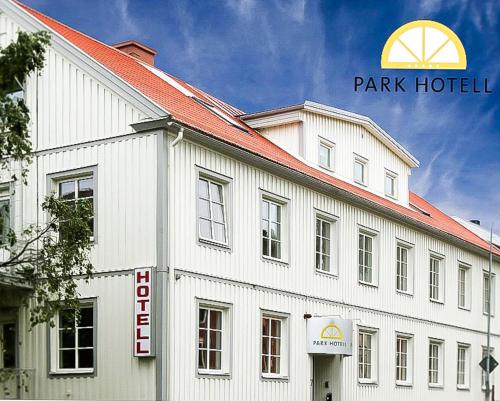 a white building with a park hotel sign on it at Park Hotell in Örnsköldsvik