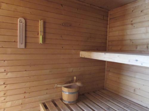 a inside of a wooden sauna with a bucket at Dům u rybníka in Nýdek