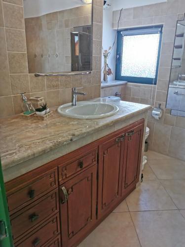 a bathroom with a sink and a mirror at Villa Diamond in Žrnovnica