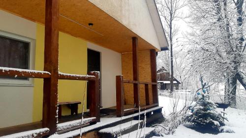 a porch of a house covered in snow at Dacha PODOBOVETS 127 in Podobovets