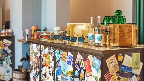 a counter with alcohol bottles on top of it at tinyTwice Hotel Wiesbaden in Wiesbaden