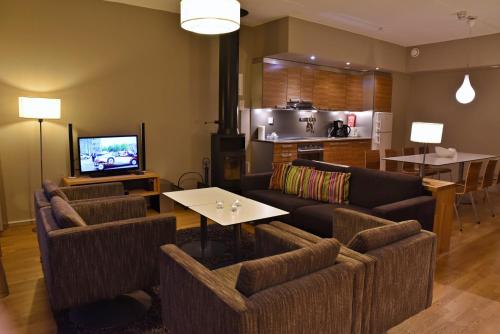a living room filled with furniture and a tv at Levi Suites Unna Mànnu in Levi