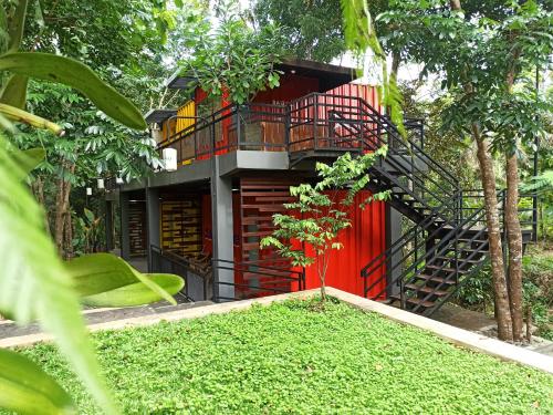 a house with a spiral staircase in the middle of a yard at Hau Eco Lodges Citumang Pangandaran in Pangandaran