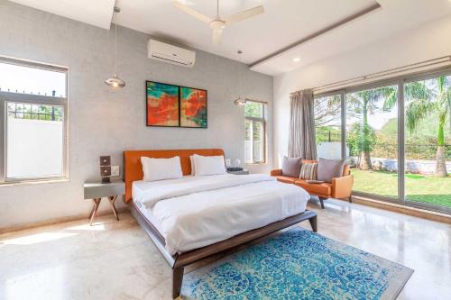 Ένα ή περισσότερα κρεβάτια σε δωμάτιο στο StayVista's White Pebbles - A Villa with Theater Room & Swimming Pool
