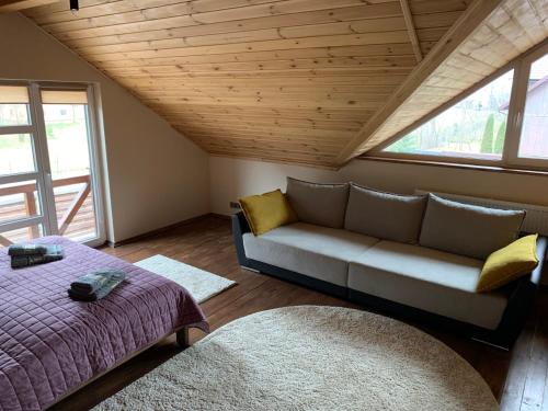 a living room with a couch and a bed at 4REST in Tukhlya