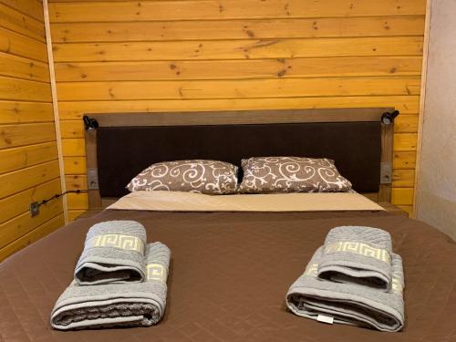 a bed in a room with towels on it at 4REST in Tukhlya
