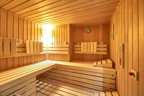 a sauna with a bench in a wooden room at Hotel Belvedere in Warnemünde