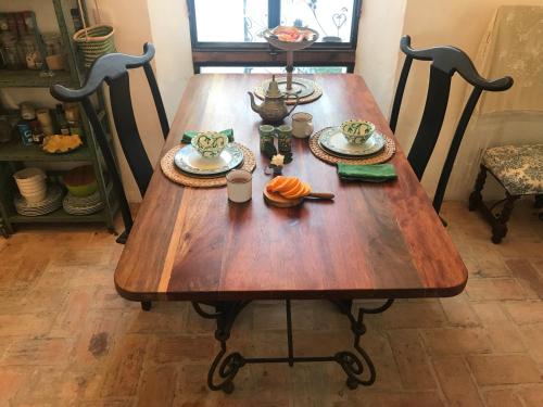 a wooden table with plates of food on it at CASA DEL TEATRO Luxury Casas Vejer Debra in Vejer de la Frontera