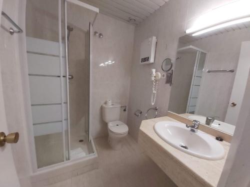a bathroom with a sink and a shower and a toilet at Hotel El Castell in Sant Boi del Llobregat