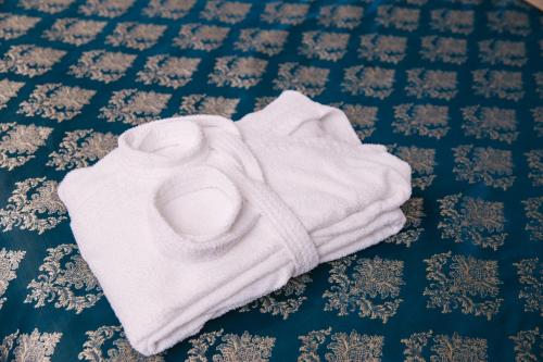 a white towel is laying on a bed at Flagman in Omsk