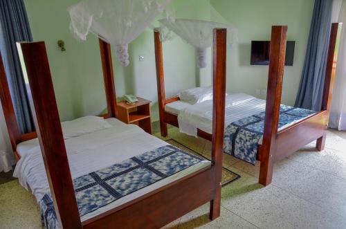 Postel nebo postele na pokoji v ubytování Njara Suites
