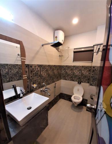 a bathroom with a sink and a toilet at DORA HOUSE in Kolkata