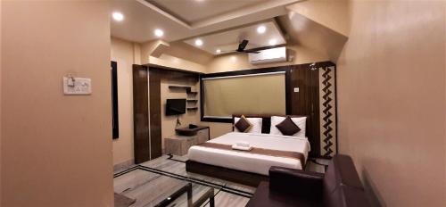 a bedroom with a bed and a large mirror at DORA HOUSE in Kolkata