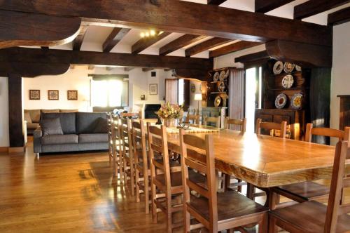 a dining room with a large wooden table and chairs at Casa rural Barbenea in Oronoz-Mugaire