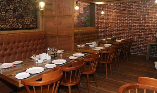 a row of tables and chairs in a restaurant at Metro Plaza Hotel by RAK Rooms, Mangaluru in Mangalore
