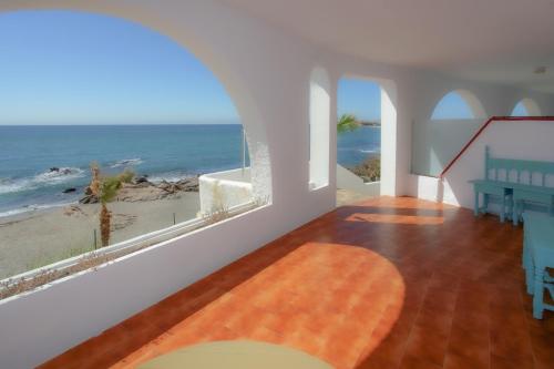 a living room with a view of the ocean at Hotel Patricia in Torreguadiaro