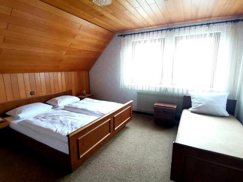 a bedroom with two beds and a window in it at Gasthaus Pflug 