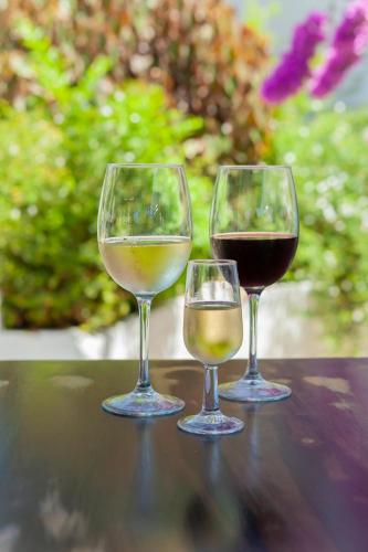 three wine glasses sitting on top of a table at Hotel Patricia in Torreguadiaro
