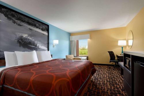 a hotel room with a large bed and a desk at Hometown Place in Olive Branch